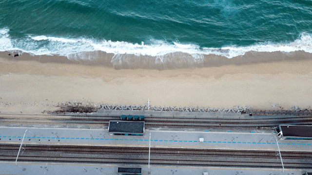 Coastal railway station next to sea.