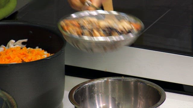 Adding chopped vegetables and fresh mussels to the rice cooker