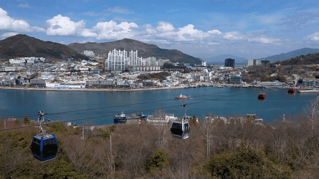 Cable car above coastal city landscape