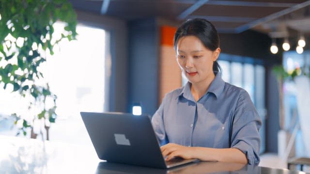 Woman working on a laptop in an office