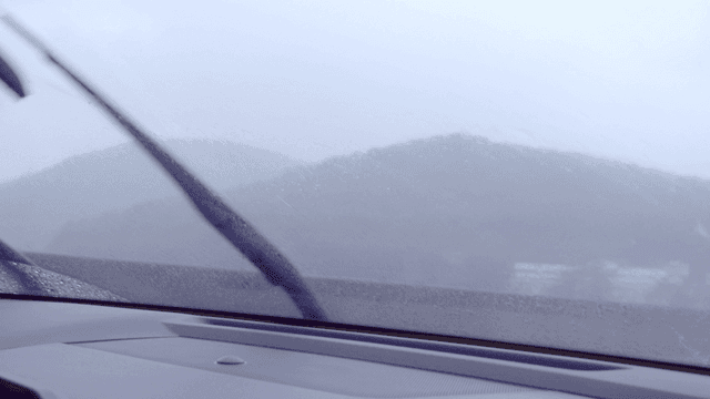 Driving in the rain with mountains in view