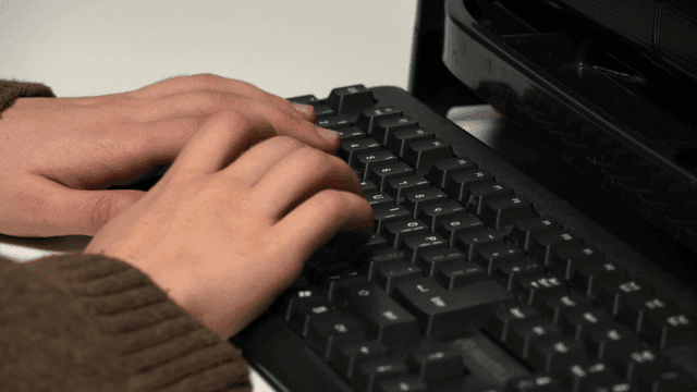 Hands typing on a keyboard