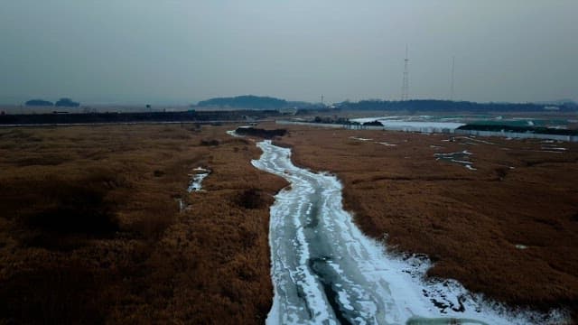 Frozen river winding through a winter landscape