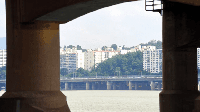 View of city buildings through a bridge