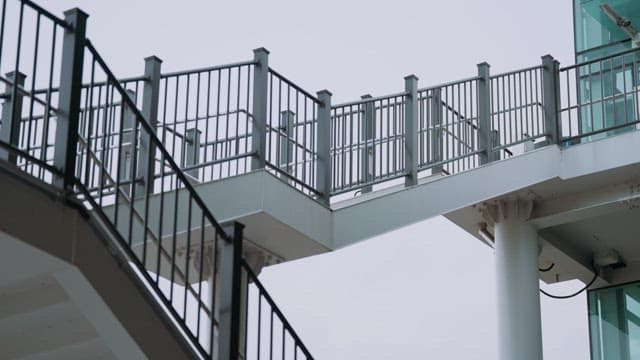 Person walking on a modern pedestrian overpass