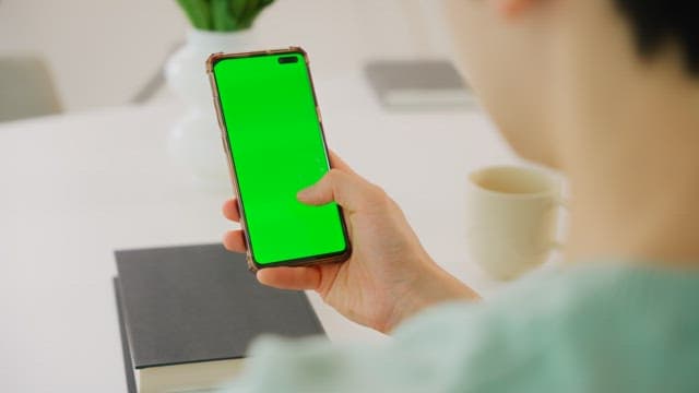 Person Using a Smartphone Indoors