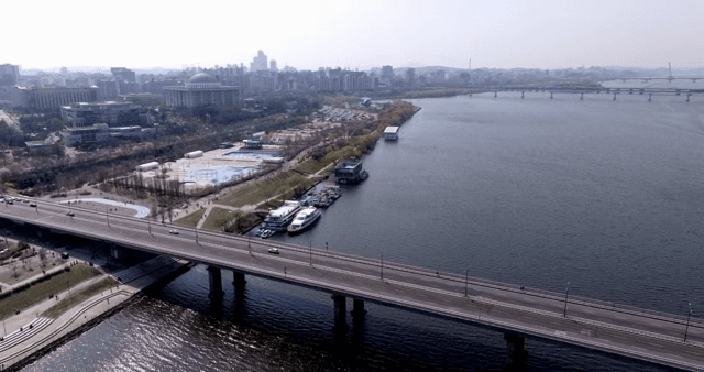 Bridge over a river with city skyline