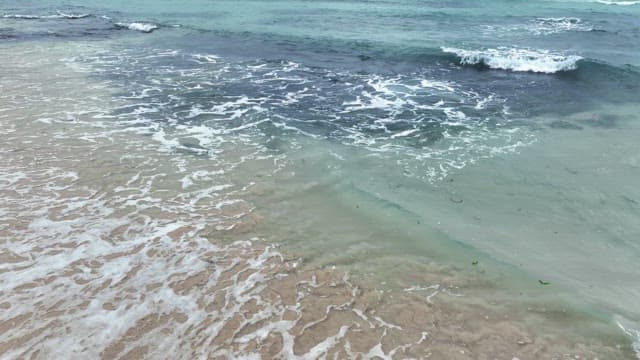 Waves gently lapping on a sandy beach