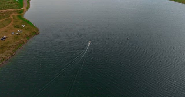 Boat sailing on a vast lake