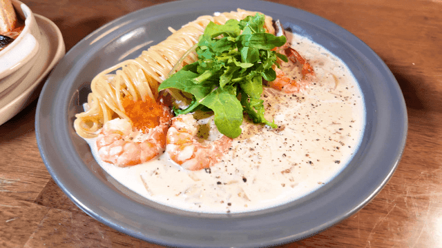 Creamy shrimp pasta being served