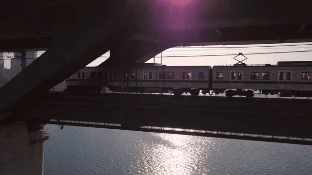 Train crossing a bridge over a river