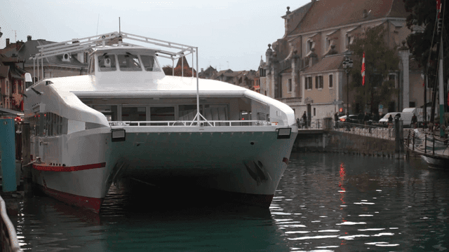 Large ferry docked on riverbank