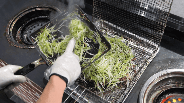 Briquette-grilled green onion bulgogi cooked on grill