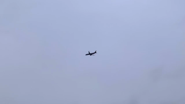 An airplane flying in the cloudy sky