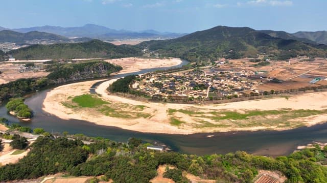 Traditional village surrounded by a river