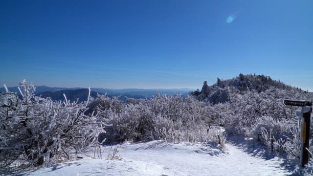 View from a snow-covered mountaintop on a sunny winter day