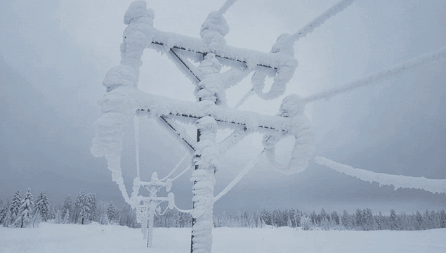 Snow-covered power lines in a winter landscape