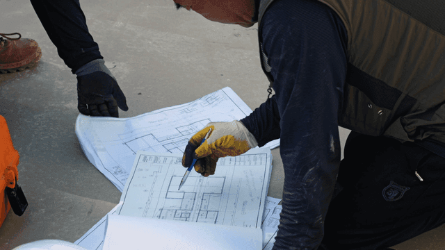 Construction worker reviewing blueprints