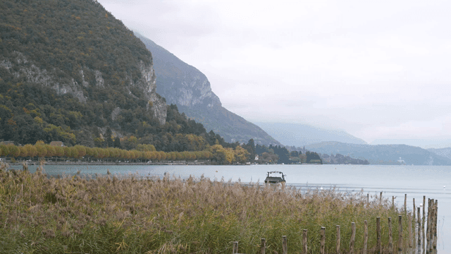 A serene lake with mountains in the background