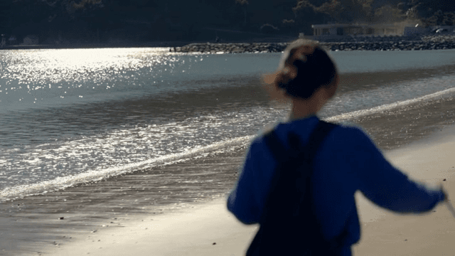 Person walking along a sunny beach
