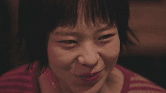 Woman talking while drinking soju