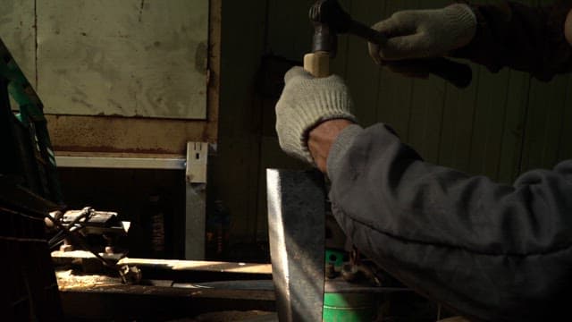 Craftsman working with metal tools indoors