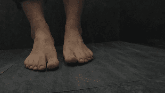 Bare feet on bottom of dark water
