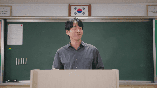 시험지를 들고 학생들에게 수고했다고 말하는 선생님