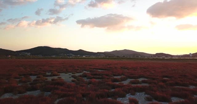 Sunset over a serene landscape with hills