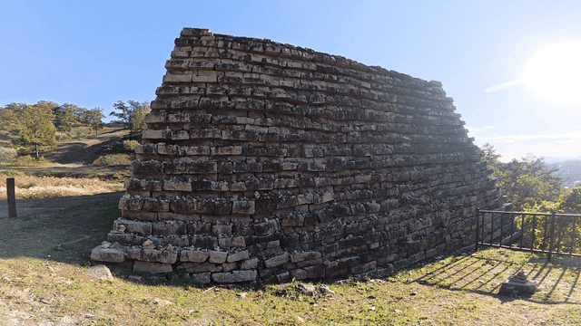 Ancient stone structure in a sunny landscape