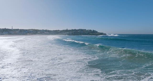 Blue Waves Rolling up and Crashing onto the Shore