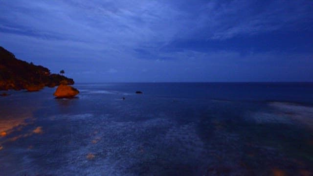 Serene Night Seascape with Rocky Shoreline