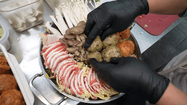 Preparing a hot pot with various ingredients