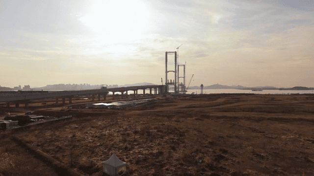 Construction site near a coast at sunset