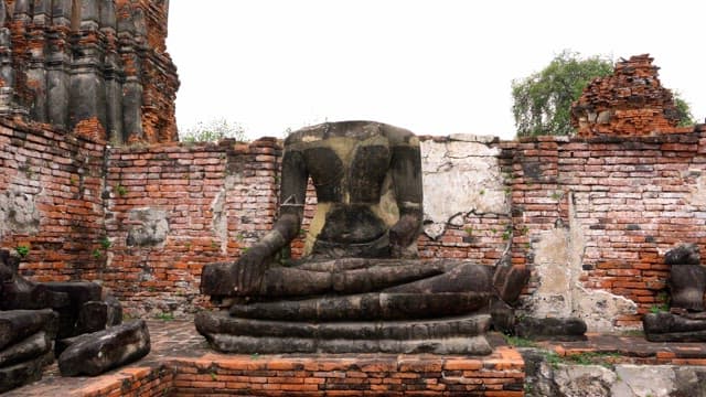 Headless Buddhist statue among ancient ruins