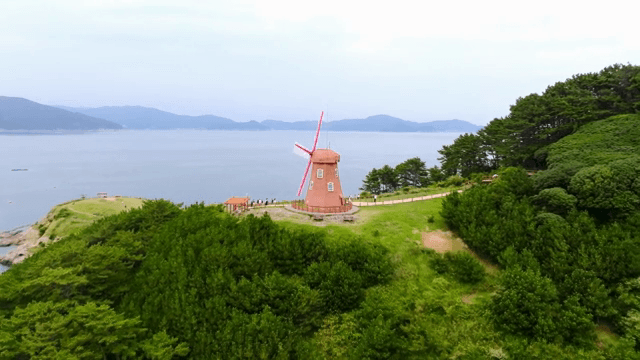 Windmill on a coastal hill with ocean view