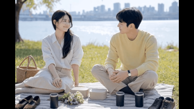 Couple enjoying picnic by river