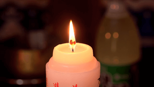 Candle burning softly indoors