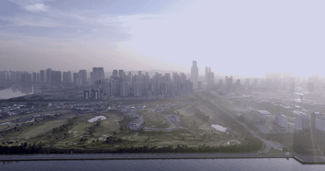 City skyline with a river and park