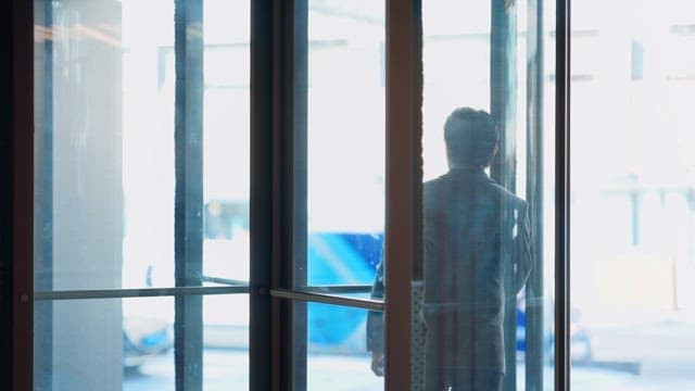 Person exiting through revolving door