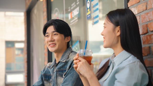 Couple enjoying iced coffee outdoors