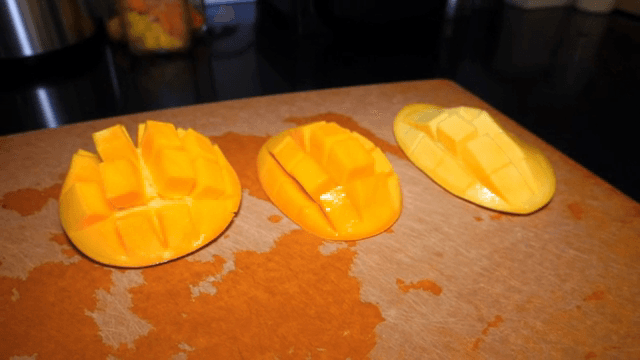 Sliced mangoes on a cutting board