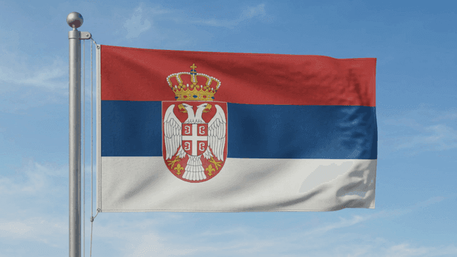 Serbian flag waving against a clear sky