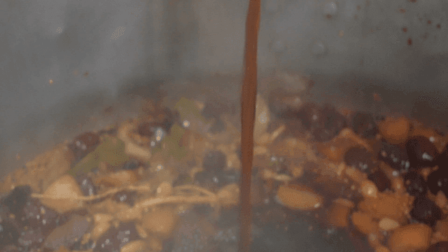 Soy sauce filled with medicinal herbs poured into pot