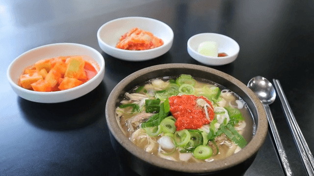 Chicken soup with side dishes on a table