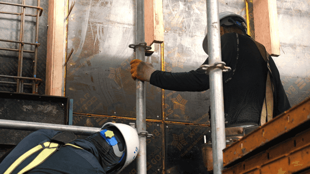 Construction workers assembling scaffolding