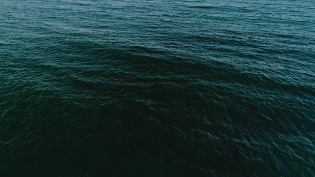 Serene Sea and Red Lighthouse