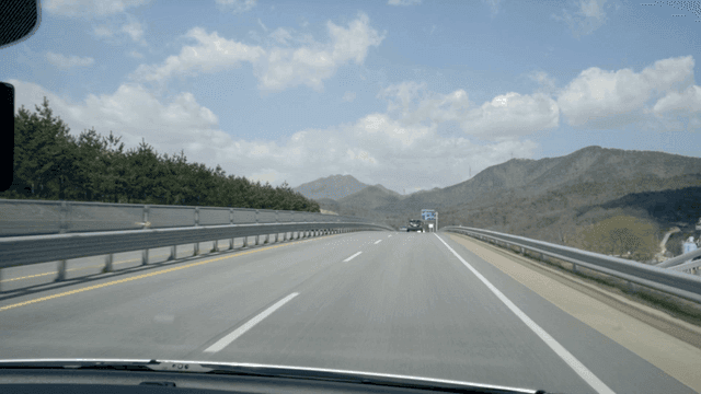 Driving on highway surrounded by mountains