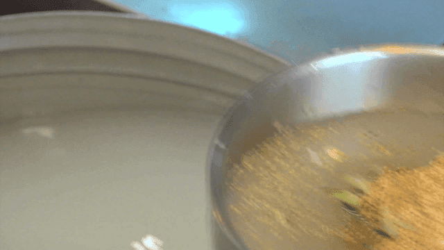 Cold buckwheat noodles being prepared with broth