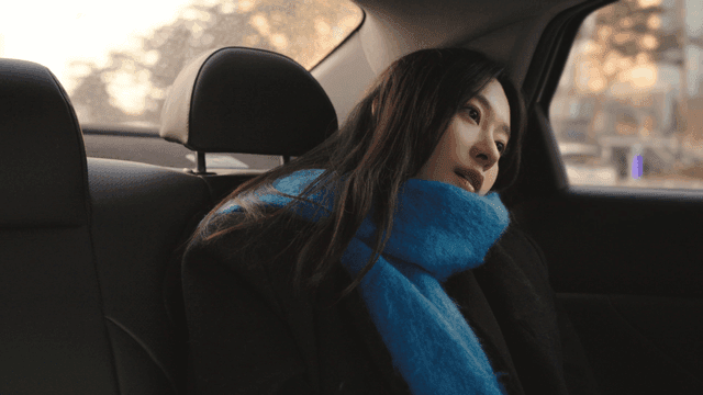 Female passenger in a taxi looking out the window